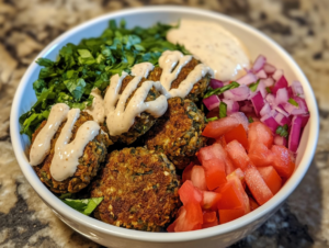 Try this falafel bowl with tahini sauce for a healthy, flavorful meal packed with plant-based protein and Mediterranean goodness.