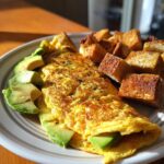 A plated 5-Ingredient Avocado Toast Omelette with avocado slices and toast.
