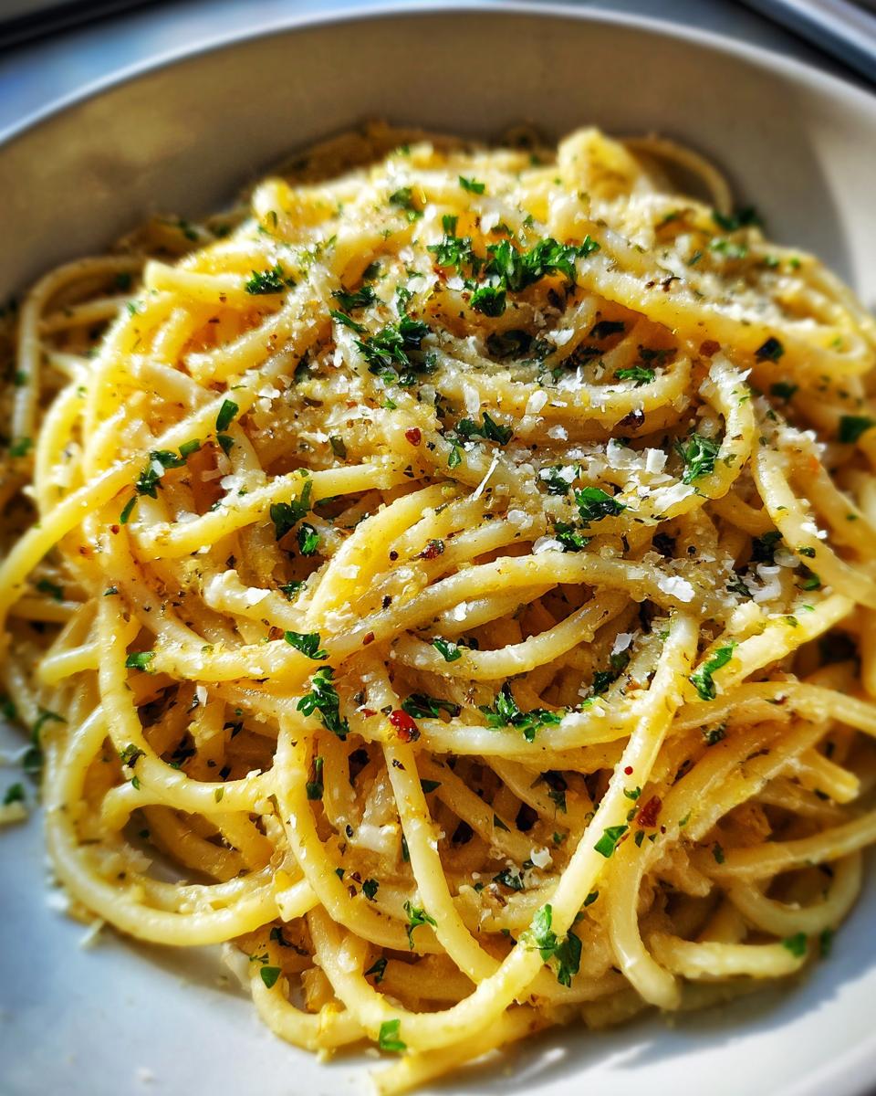 Close-up of 5-Minute Lazy Girl Pasta with garlic, parmesan, and herbs in a bowl.