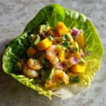 Close-up of an Avocado Mango Shrimp Lettuce Wrap, showcasing fresh ingredients.
