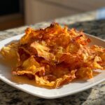 Close-up of a plate of delicious Baked Apple Cinnamon Oat Chips, golden and crispy.
