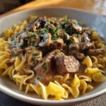 Close-up of Classic Beef Stroganoff with egg noodles, beef, mushrooms, and creamy sauce.