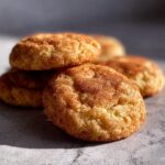 Close-up of freshly baked Brown Butter Snickerdoodle Christmas Cookies, dusted with cinnamon sugar.