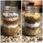 Two mason jars filled with layered ingredients for cookie mix in a jar, including chocolate chips, oats, and flour.