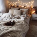 A cozy winter bedroom makeover featuring a bed with plush pillows, a chunky knit blanket, and warm fairy lights.