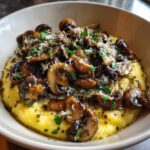 Close-up of creamy polenta with mushrooms, garnished with parsley and cheese. A delicious Creamy Polenta with Mushrooms.