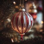 A festive red and white striped custom photo ornament with glitter, hanging on a Christmas tree.