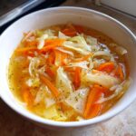 A bowl of Detox Cabbage & Carrot Soup, a healthy and flavorful soup.
