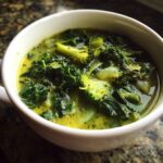 Close-up of a bowl of Detox Green Vegetable Soup with broccoli and kale.