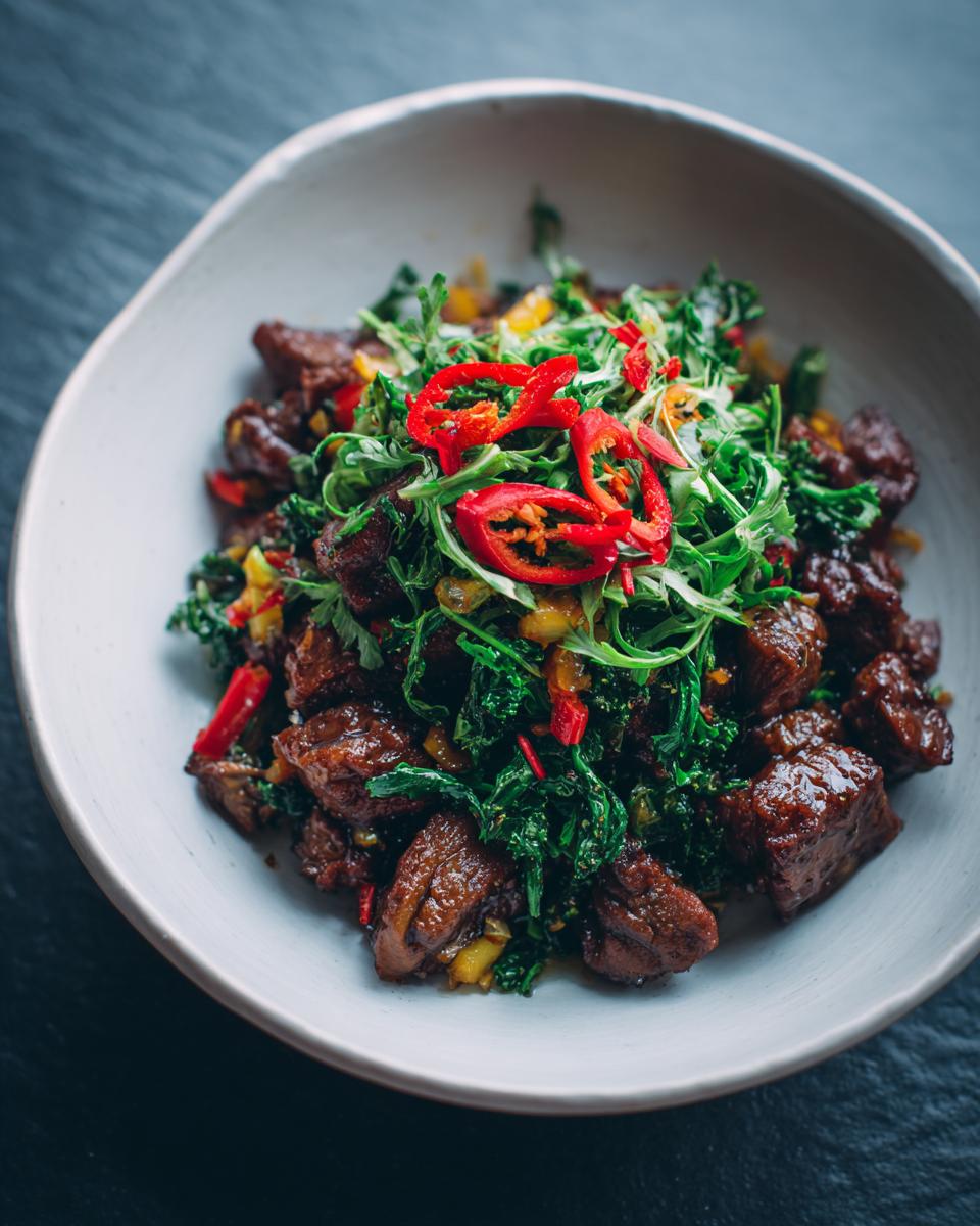 A close-up of a bowl filled with delicious food, featuring cubed meat, greens, and chili peppers, perfect for a DIY candle gift inspiration.