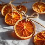 Close-up of dried orange slices strung together with twine, showcasing their vibrant color and texture for a dried orange garland.