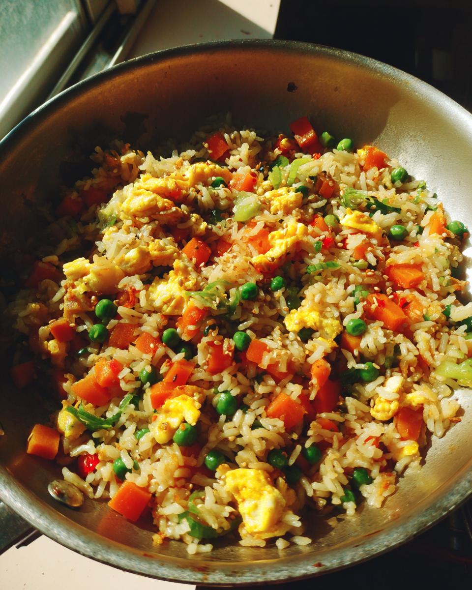 Close-up of Easy Veggie Fried Rice with Egg in a skillet, with carrots, peas, and egg.