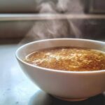 Close-up of a steaming bowl of delicious Garlic Miso Ramen-Inspired Broth.