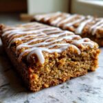 Close-up of a moist Gingerbread Cookie Bar drizzled with white icing.