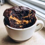 Close-up of a Greek Yogurt Chocolate Peanut Butter Mug Cake with peanut butter filling.