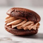 Close-up of a delicious Hot Chocolate Stuffed Sandwich Cookie with creamy filling.