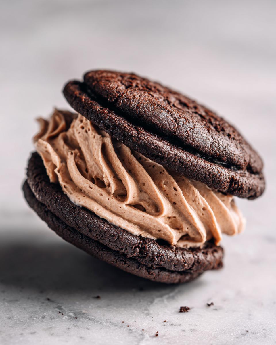 Close-up of a Hot Chocolate Stuffed Sandwich Cookie, showing the chocolate cookie and filling.