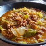 Close-up of a bowl of Keto Cabbage & Sausage Soup, showing cabbage, sausage, and broth.