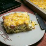 A slice of golden-brown Leek Gratin on a plate, ready to be enjoyed. A comforting dish.