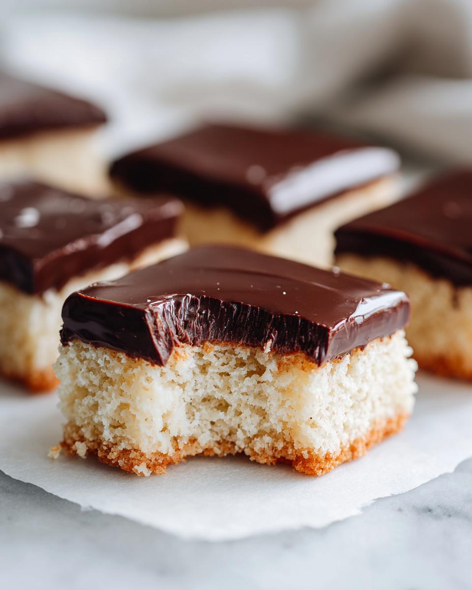 Close-up of a North Pole Chocolate-Dipped Shortbread Bar with a bite taken out.