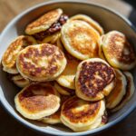 Close-up of a bowl filled with Nutella-Stuffed Pancake Cereal, a delicious breakfast treat.