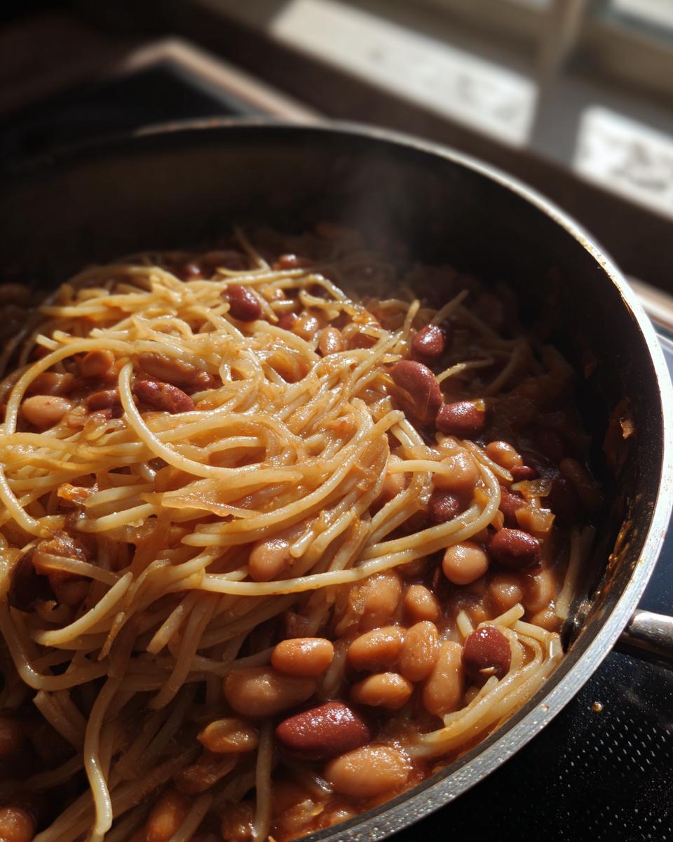 Close-up of One-Pot Pasta e Fagioli Soup with beans and spaghetti in a pot.