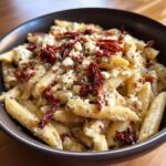 Close-up of One-Pot Sun-Dried Tomato Feta Pasta in a bowl, with sun-dried tomatoes and feta cheese.