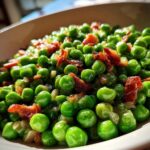 Close-up of Peas with Pancetta in a white bowl, a quick and easy recipe.