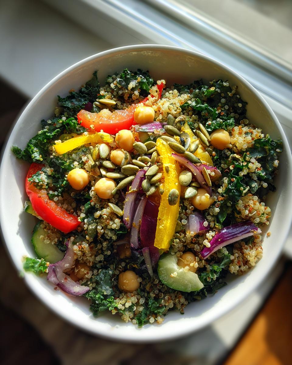 Overhead shot of a healthy Quinoa Kale Power Bowl with colorful vegetables and seeds.