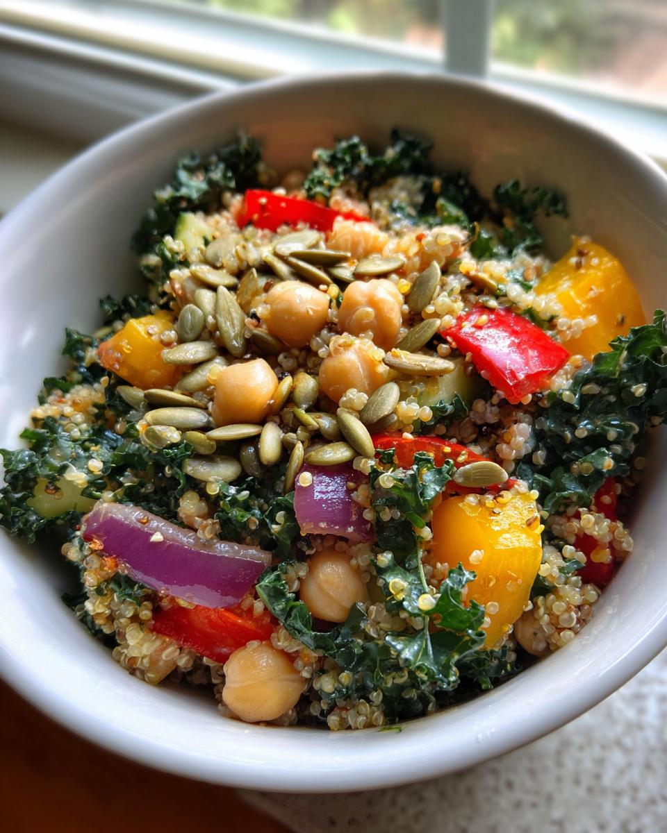 Close-up of a Quinoa Kale Power Bowl with chickpeas, vegetables, and seeds.