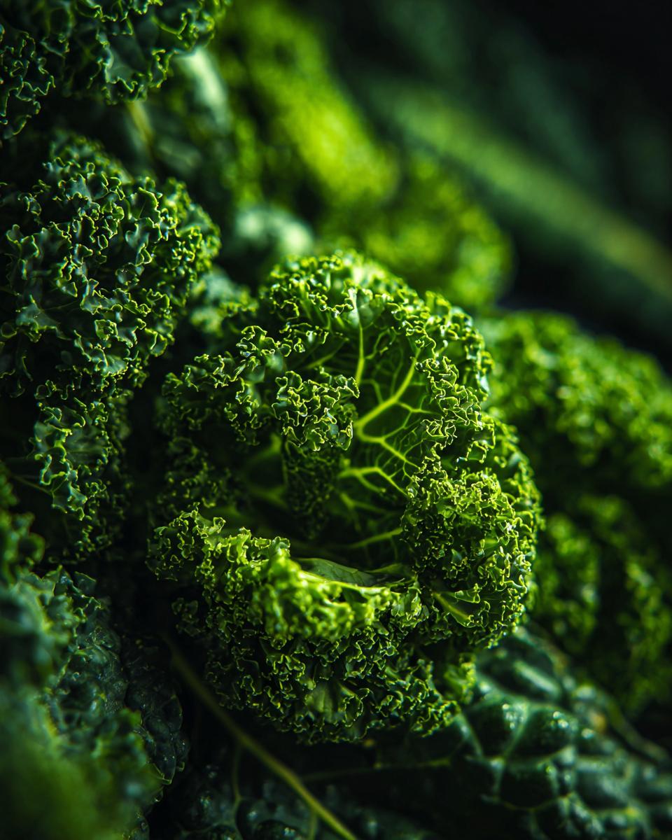 Close-up of fresh, vibrant green curly kale, ingredient for a Quinoa Kale Power Bowl.