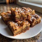 Close-up of Salted Caramel Pretzel Blondies drizzled with caramel and sprinkled with sea salt.