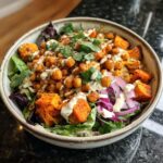 A vibrant Spiced Chickpea and Sweet Potato Buddha Bowl with roasted sweet potato, chickpeas, and tahini dressing.