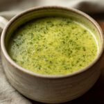 Close-up of a bowl filled with creamy Cream Of Celery Soup.