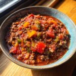A delicious bowl of No Bean Chili with ground meat, tomatoes, and bell peppers.