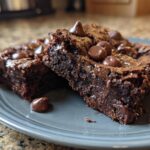 Close-up of two chocolate brownies, the dessert that disappears in minutes, topped with chocolate chips.