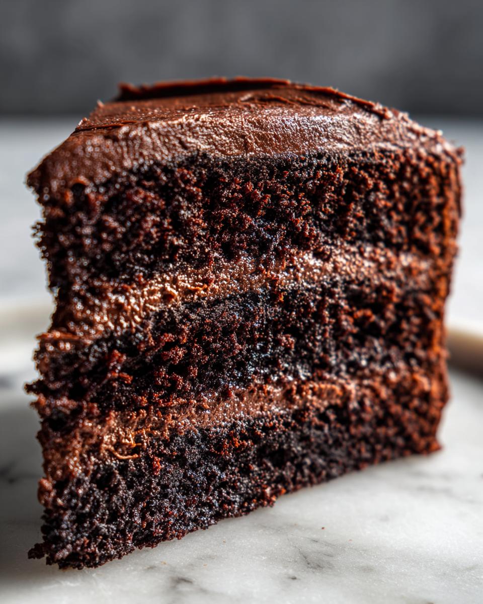 Close-up of a slice of the The Chocolate Recipe Everyone Is Talking About cake, showing layers of chocolate cake and frosting.