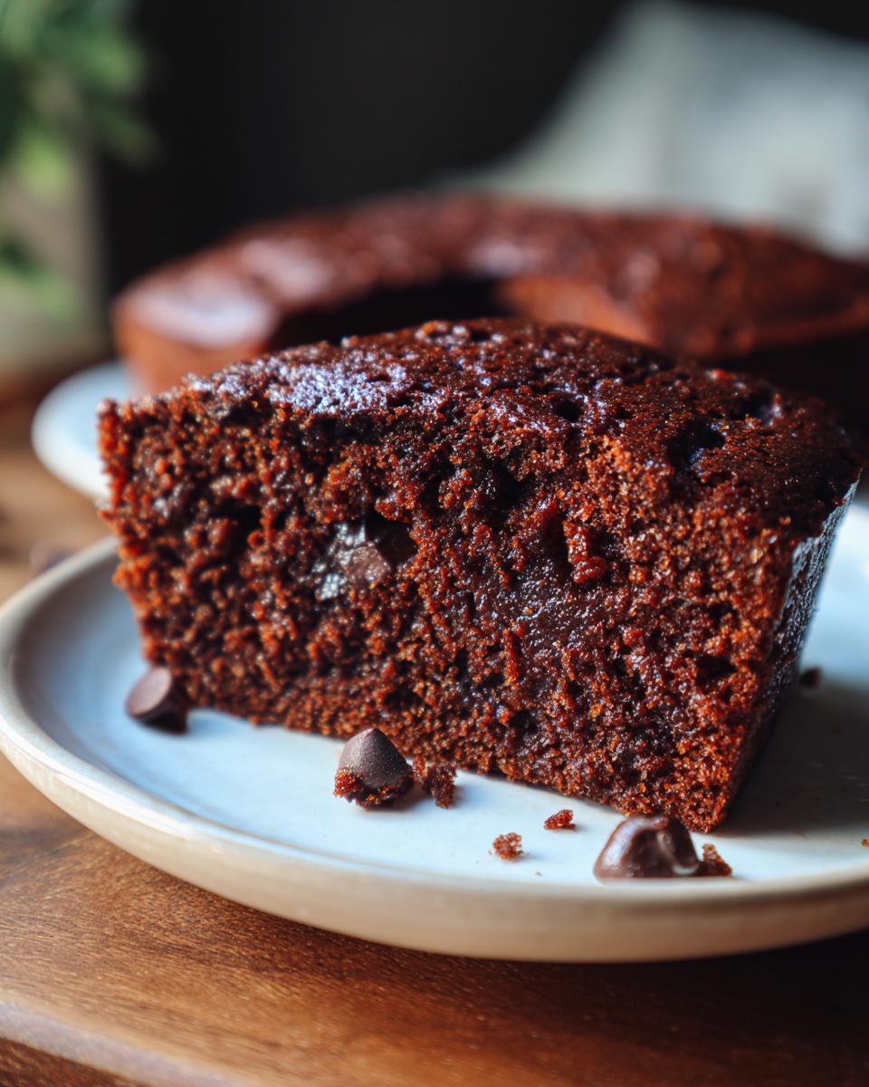 Close-up of a slice of the No Mixer Dessert That Never Fails, a rich chocolate cake.