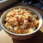 A bowl of Budget Homemade Cat Food with rice, carrots, and herbs.