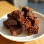 Pile of homemade Chicken Liver Cat Treats on a white plate, ready to be enjoyed.