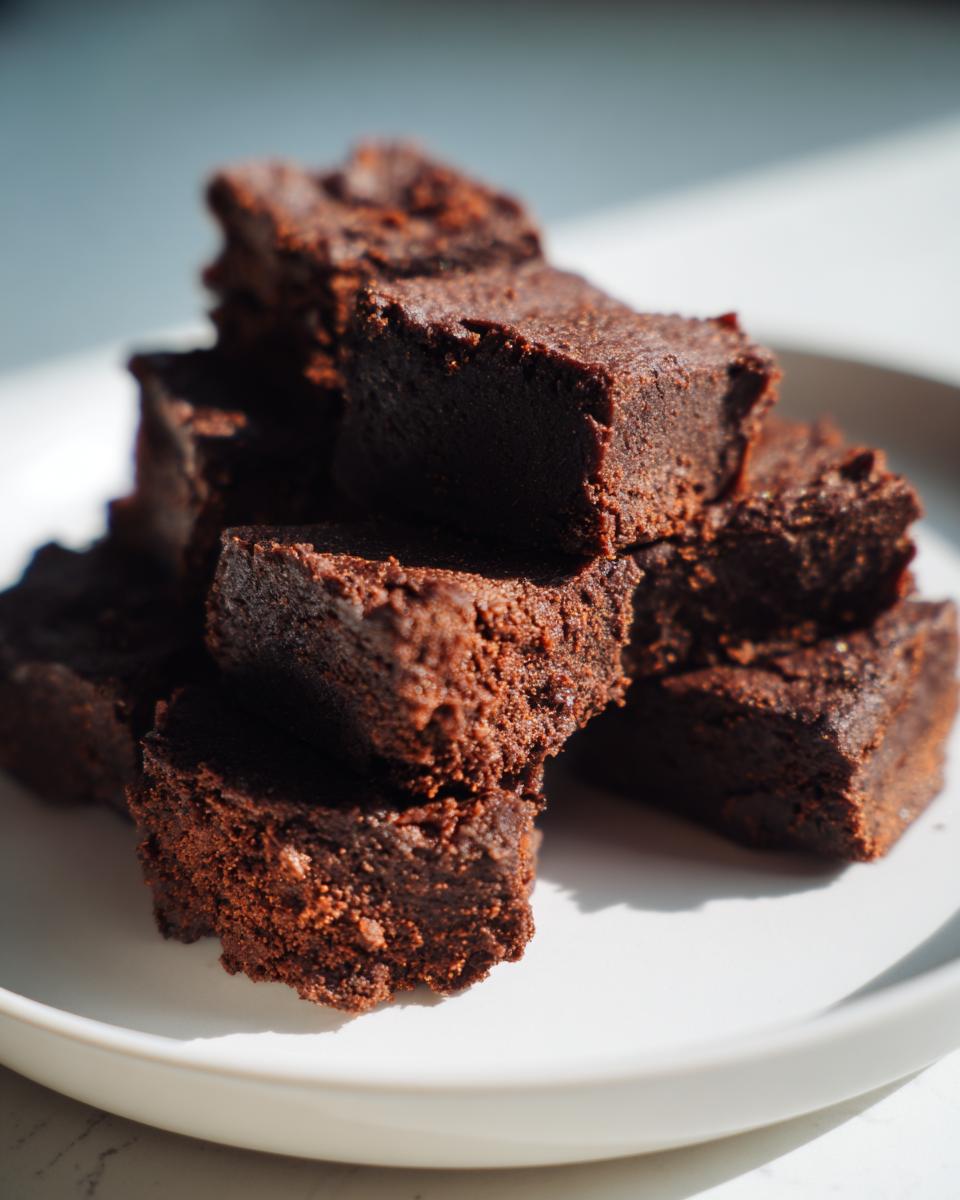 Close-up of a stack of homemade Chicken Liver Cat Treats on a white plate.