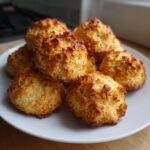 Pile of golden-brown Grain-Free Fish Cat Treats on a white plate.