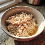 A bowl of High-Calorie Cat Recovery Meal, including rice and shredded chicken.