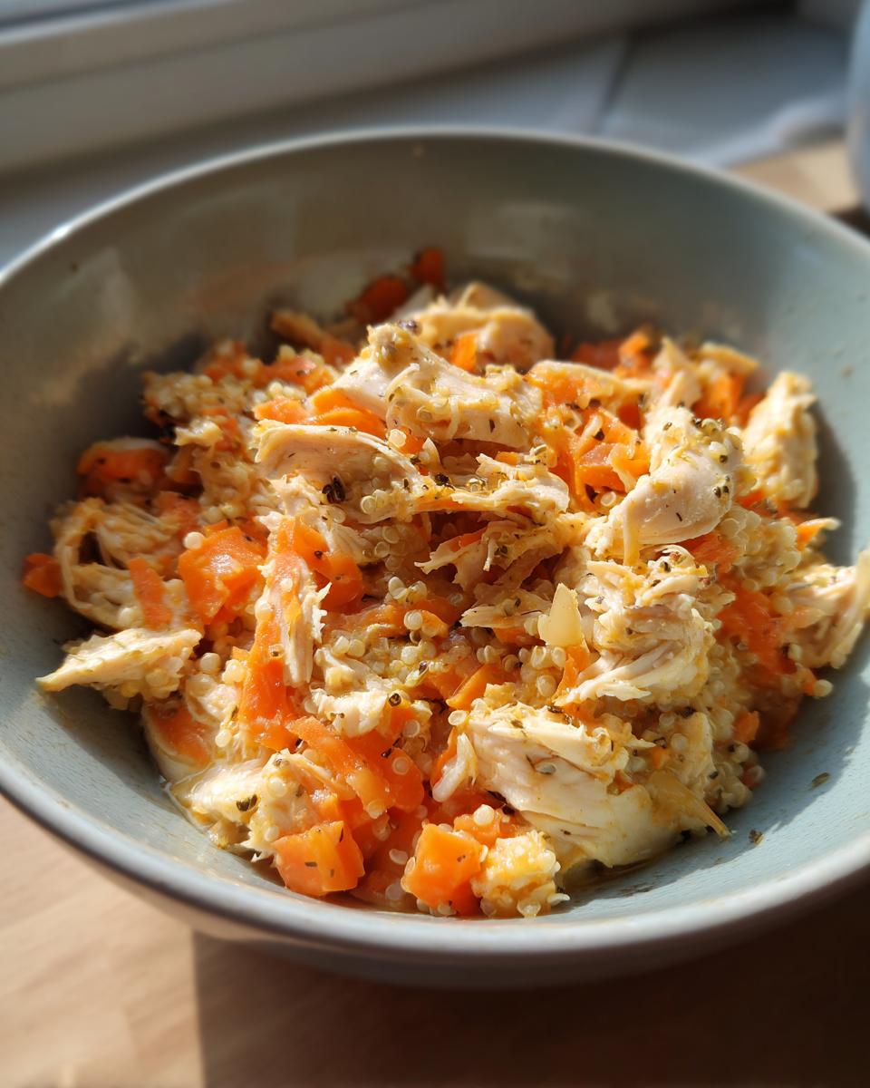 Close-up of a High-Protein Senior Cat Meal in a bowl, with chicken and carrots.