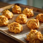 Close-up of freshly baked hypoallergenic cat treats on parchment paper.