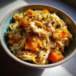 Close-up of an Indoor Cat Weight Control Meal in a blue bowl with chicken and pumpkin.