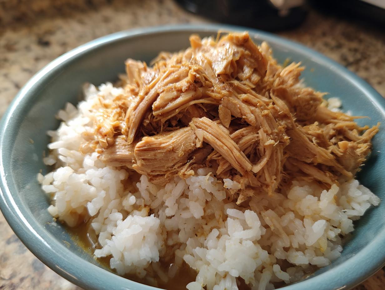 A bowl of homemade Sensitive Stomach Cat Meal, with white rice and shredded meat.