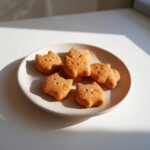 Plate of homemade Soft Pumpkin Cat Treats shaped like cats, perfect for a tasty snack.