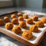 Close-up of freshly baked Soft Senior Cat Treats on a baking sheet, ready to be enjoyed.