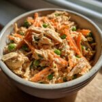 Close-up of a Spring Chicken Cat Meal Bowl with shredded chicken, peas, and carrots.